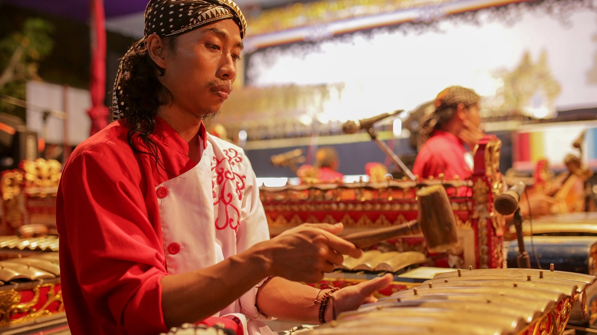 Indonesian playing traditional instrument in Bali.