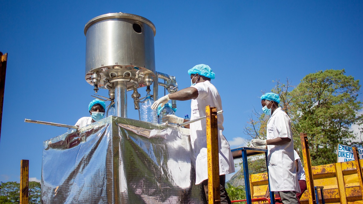 Workers handling a mineral water filler machine in Manica, Mozambique.