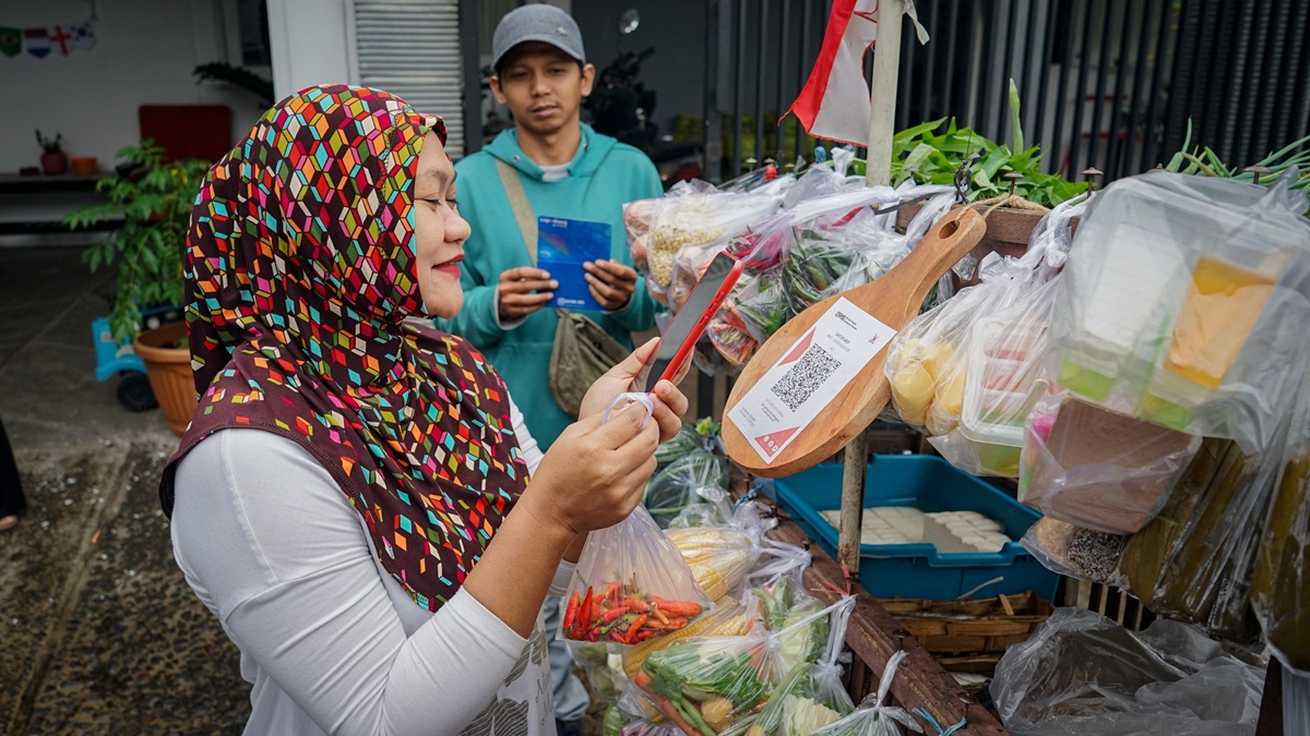 A customer makes a digital payment at a market in Malang, Indonesia.