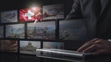 Switzerland eCommerce displayed on multiple screens with man typing on keyboard