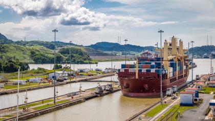 A cargo ship passes through the Panama Canal in Central America.