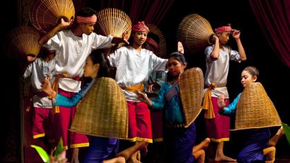Folk dancers perform the Harvest Dance in traditional costumes in Phnom Penh, Cambodia.