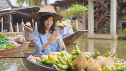 A woman vendor sells local fruits online at a floating market in Thailand’s Ratchaburi Province. 