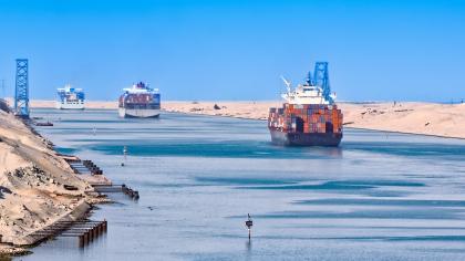 Container ships sail through the Suez Canal.