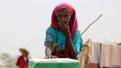 A woman receives food aid in Hajjah Governorate, Yemen.