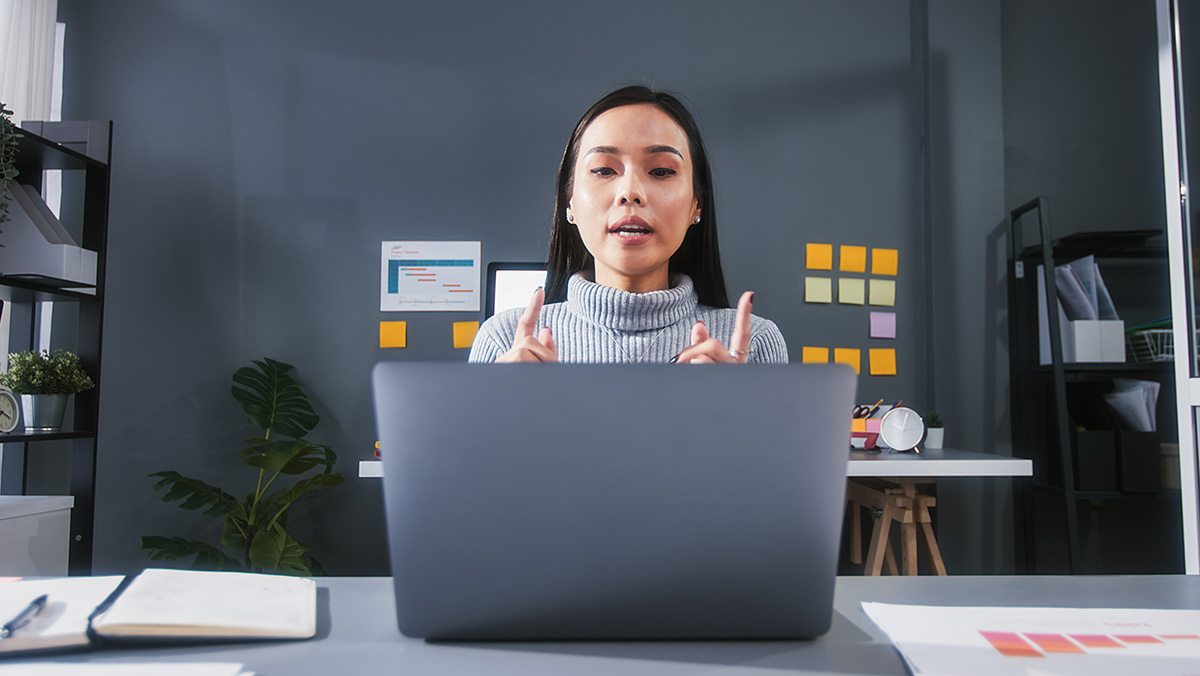 Woman working behind computer in digital economy