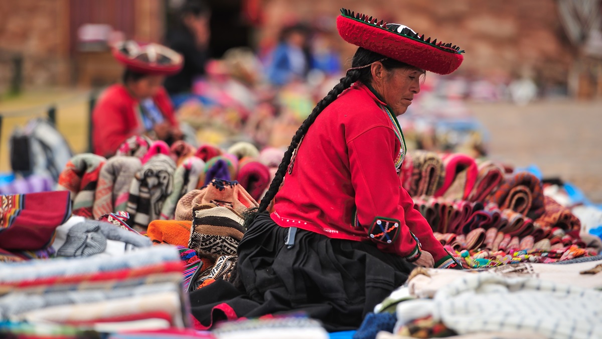 Women sell Andean textile products at a market in Chinchero, Peru.
