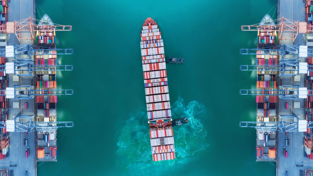 An aerial view of a container vessel leaving port